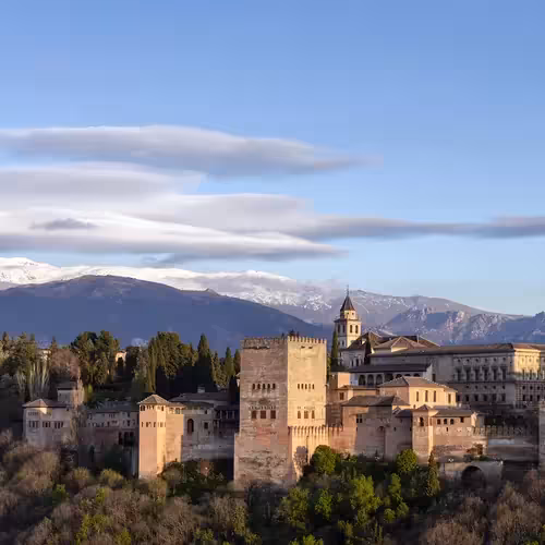 The Alhambra in Granada, with the snowy peaks of the Sierra Nevada behind.
