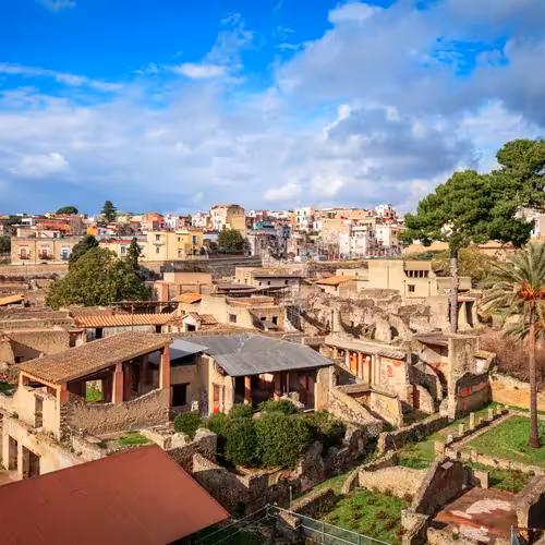 Roman houses in the ruins of Herculaneum, with the modern town of Ercolano behind.