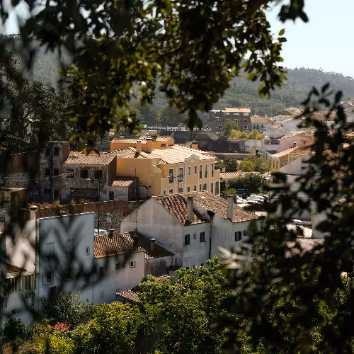 Scenic view of traditional architecture in Monchique, Algarve, Portugal, showcasing charming rooftops and lush greenery for a serene travel destination.