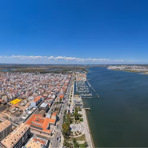 Aerial view of Vila Real de Santo António, showcasing the scenic Guadiana River and vibrant architecture in the Algarve region, Portugal.