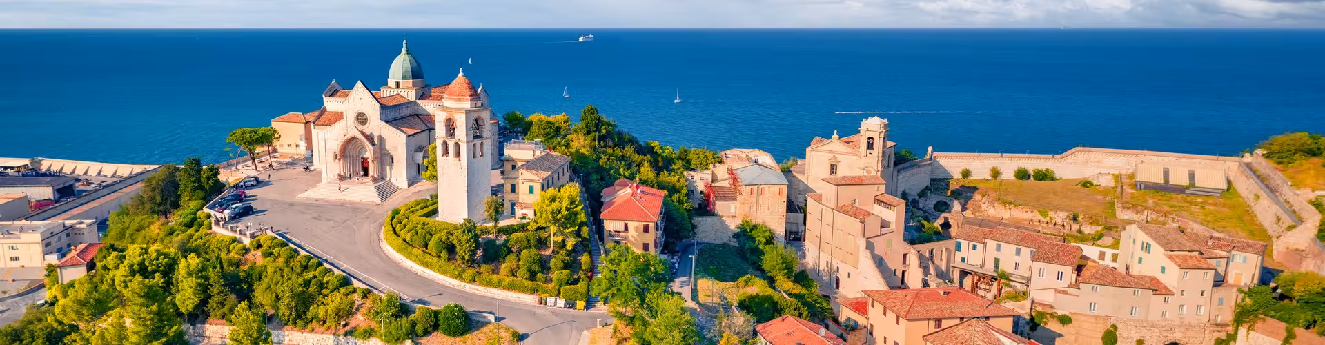Ancona's vibrant port illuminated at dusk, showcasing the city's maritime heritage and bustling harbor life.