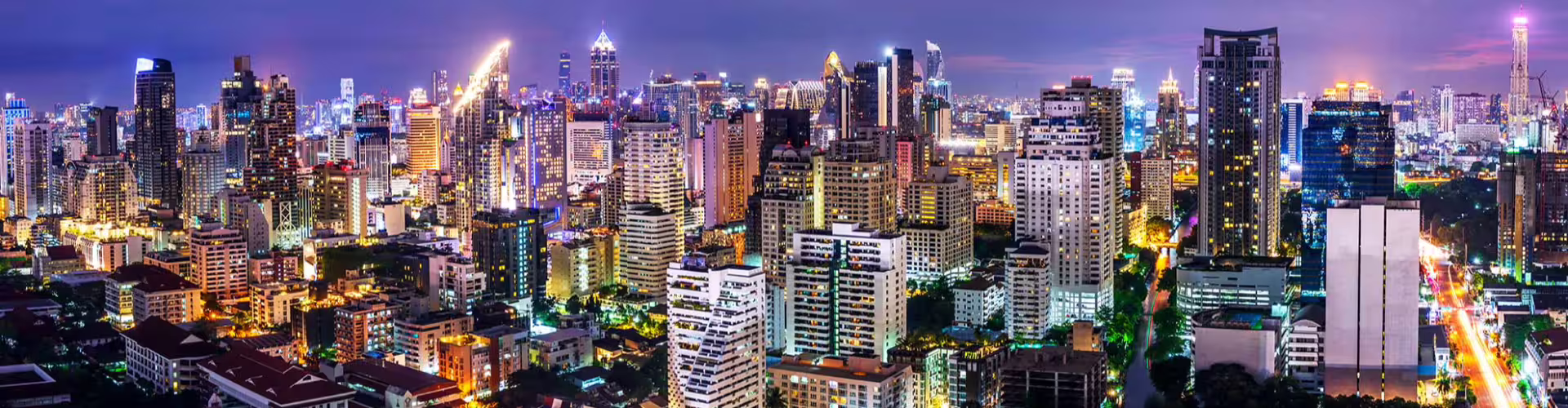 Vibrant nighttime skyline of Gauteng Province with illuminated skyscrapers and bustling city streets showcasing urban life.