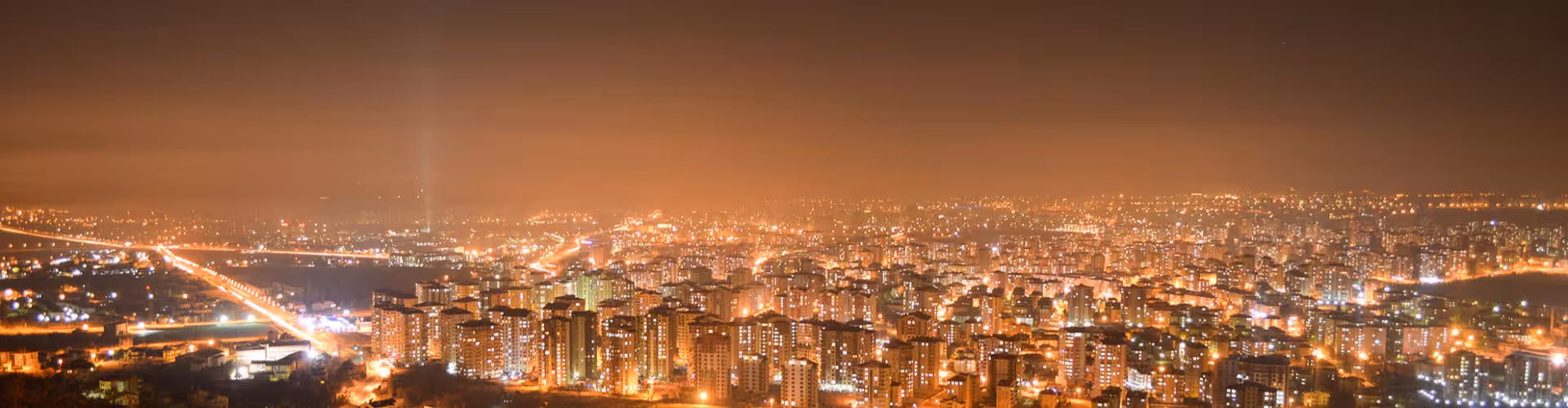 Panoramic night view of Kayseri city skyline in Central Anatolia, Turkey, with glowing lights and modern high-rise buildings near Mount Erciyes