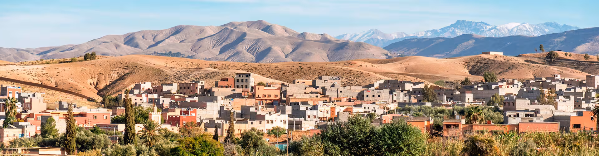 Panoramic view of Lalla Takerkoust village near Marrakech with Atlas Mountains backdrop, a gateway to Lake Lalla Takerkoust desert landscapes and outdoor adventures.