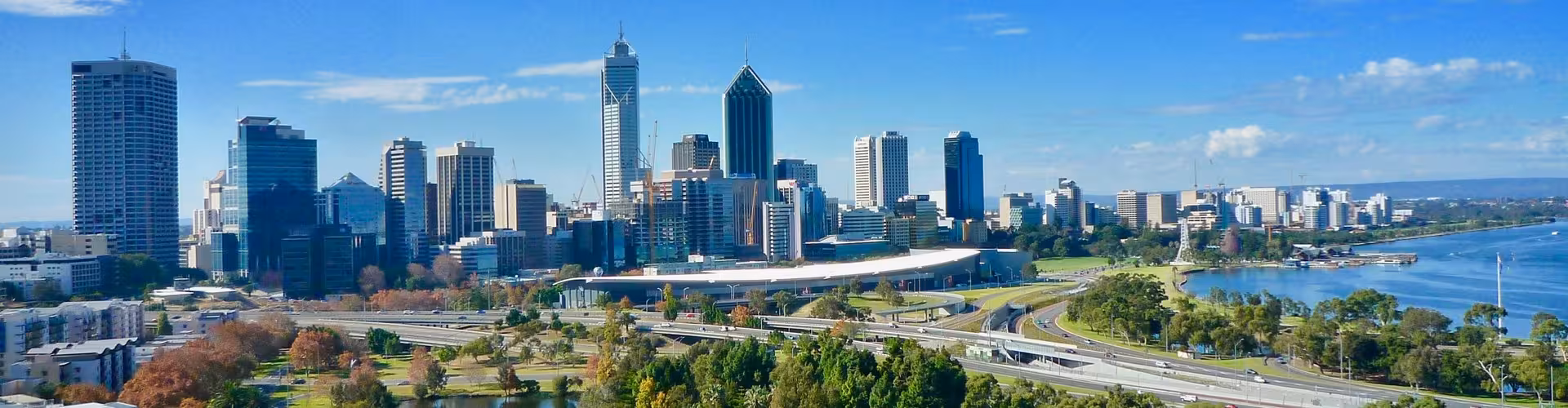 Elizabeth Quay pedestrian bridge at sunset on the Swan River in Perth, Western Australia, showcasing the CBD waterfront skyline and riverside promenade