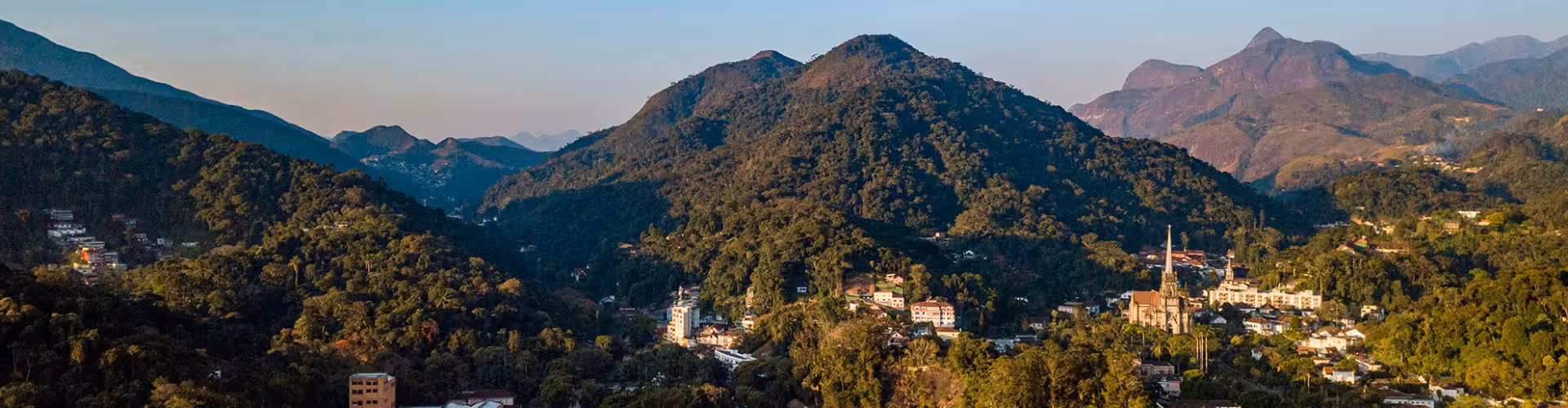A breathtaking view of the lush green mountains surrounding Petrópolis, Brazil, highlighting its stunning natural beauty and tranquil setting.