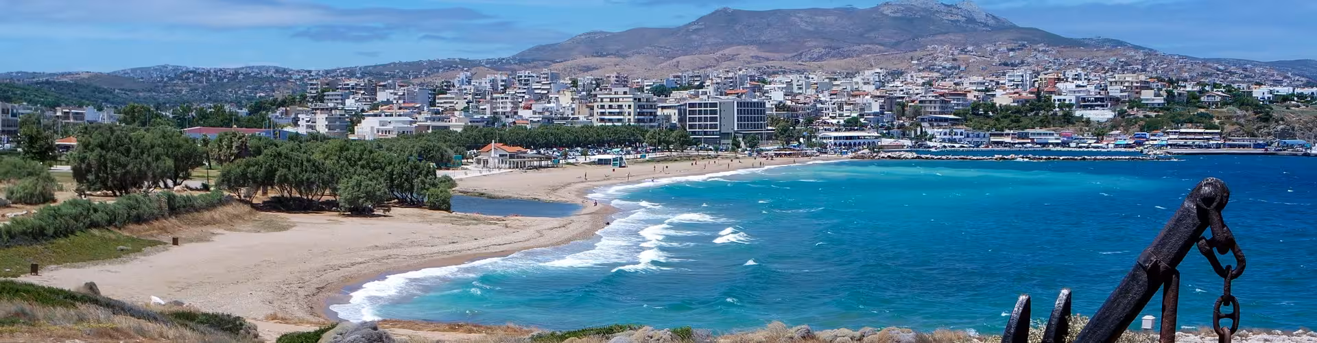 Panoramic view of Rafina, Attica, Greece, showcasing the sandy beach, turquoise Aegean Sea and vibrant waterfront near Rafina Port gateway to the Cyclades