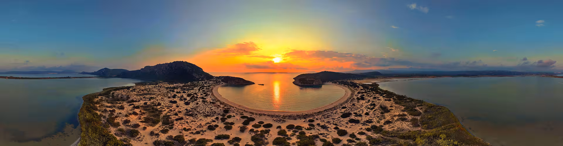 Panoramic sunset over Voidokilia Beach, the iconic omega-shaped bay near Pylos in Messinia, Peloponnese, Greece, with golden sand dunes and calm turquoise waters.