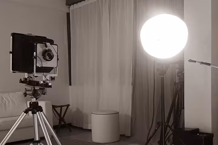 Vintage large-format camera and studio light setup for 19th century metal portrait experience in Porto, Portugal