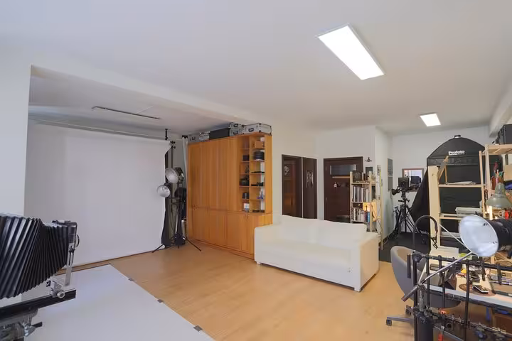 Porto, Portugal studio set for 19th-century metal portrait tour, with backdrop, vintage camera and lighting gear