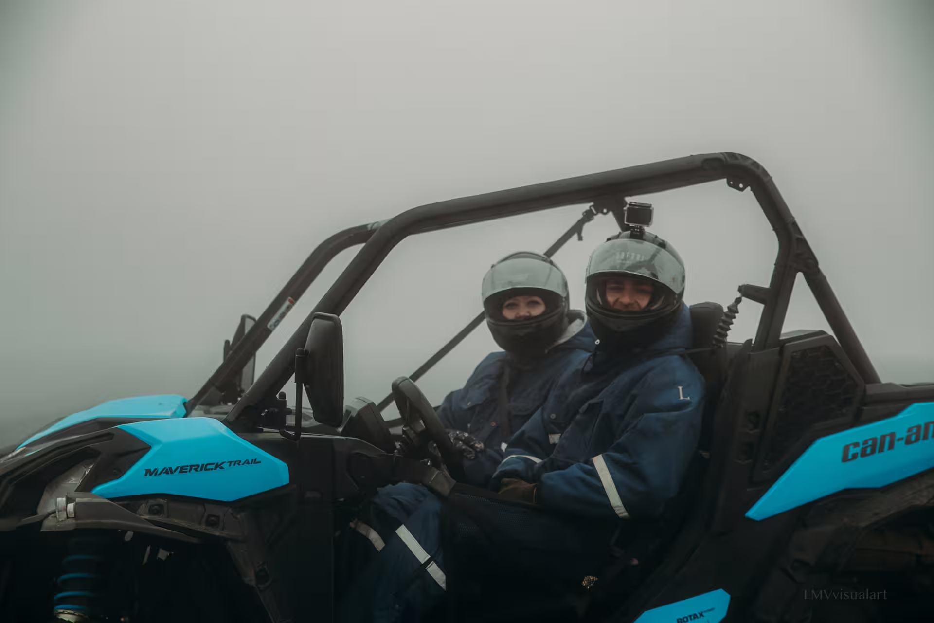 Two adventurers in helmets enjoy a thrilling 2-hour buggy ride through misty lava fields, perfect for an exciting outdoor adventure.