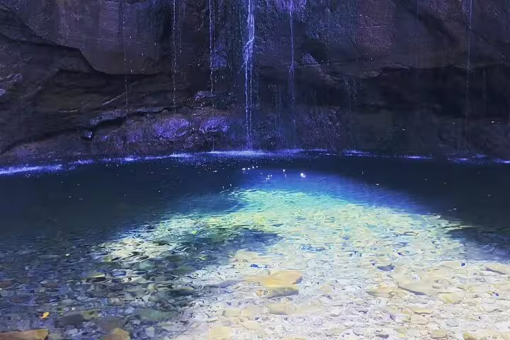 Crystal-clear pool beneath cascading waterfalls, a highlight of the 25 Fontes & Risco self-guided hiking tour.