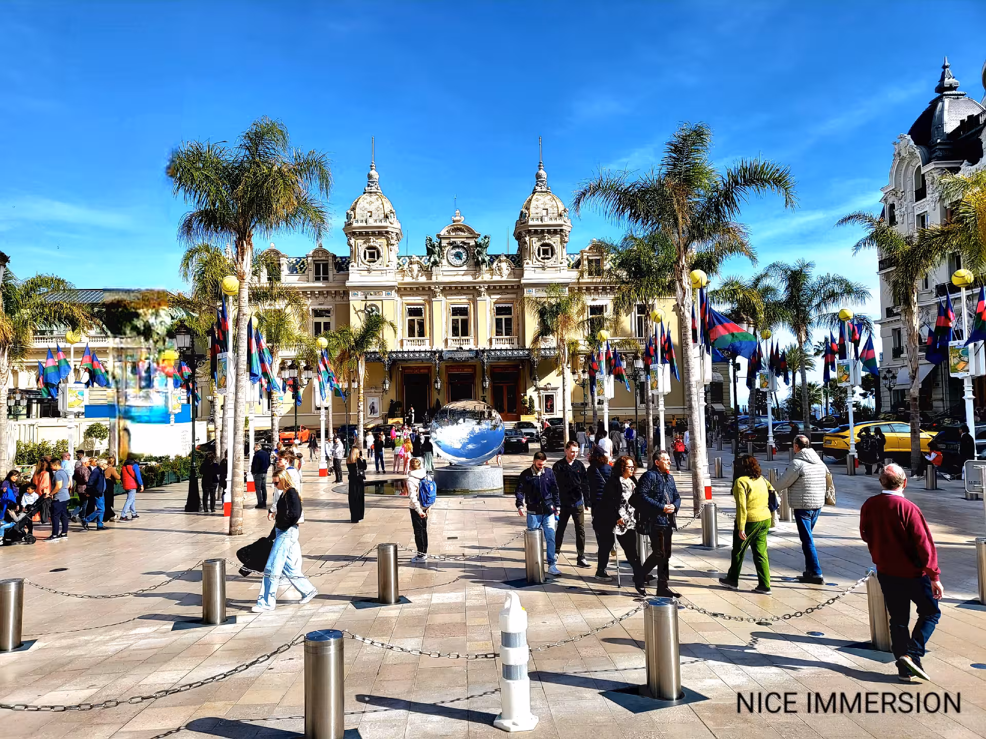 Vibrant city square with historic architecture and flags, ideal for a 3 countries in 1 day excursion.