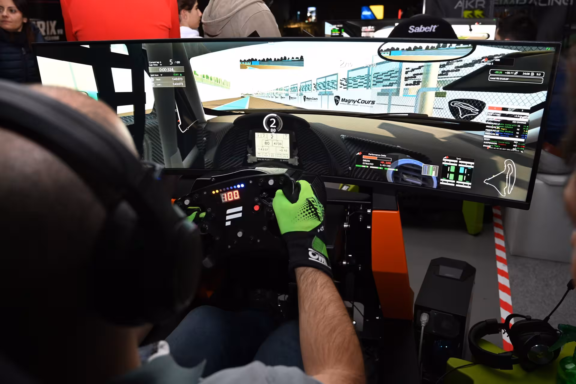 Hands on wheel in 30’ racing simulator with ultra-wide screen, realistic track driving and live telemetry display