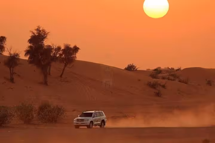 4x4 jeep crossing Hurghada desert dunes at sunset, 3-hour safari from El Gouna Makadi Bay Soma Bay