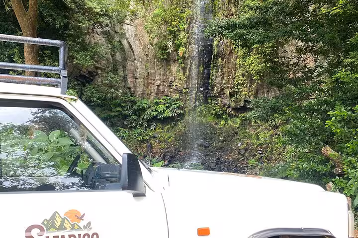 4x4 jeep by lush Madeira waterfall on Pico do Areeiro to Ponta São Lourenço East expedition adventure