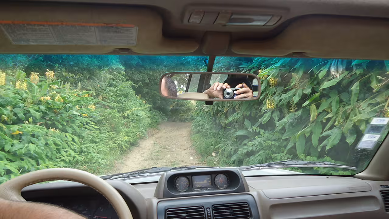 4x4 jeep driving a narrow dirt track through lush Azores jungle on a private off-road tour from Ponta Delgada