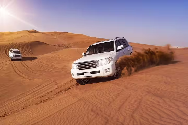 4x4 off-road driving across Sahara sand dunes near Merzouga, adventure highlight of an 8 day desert tour from Marrakech