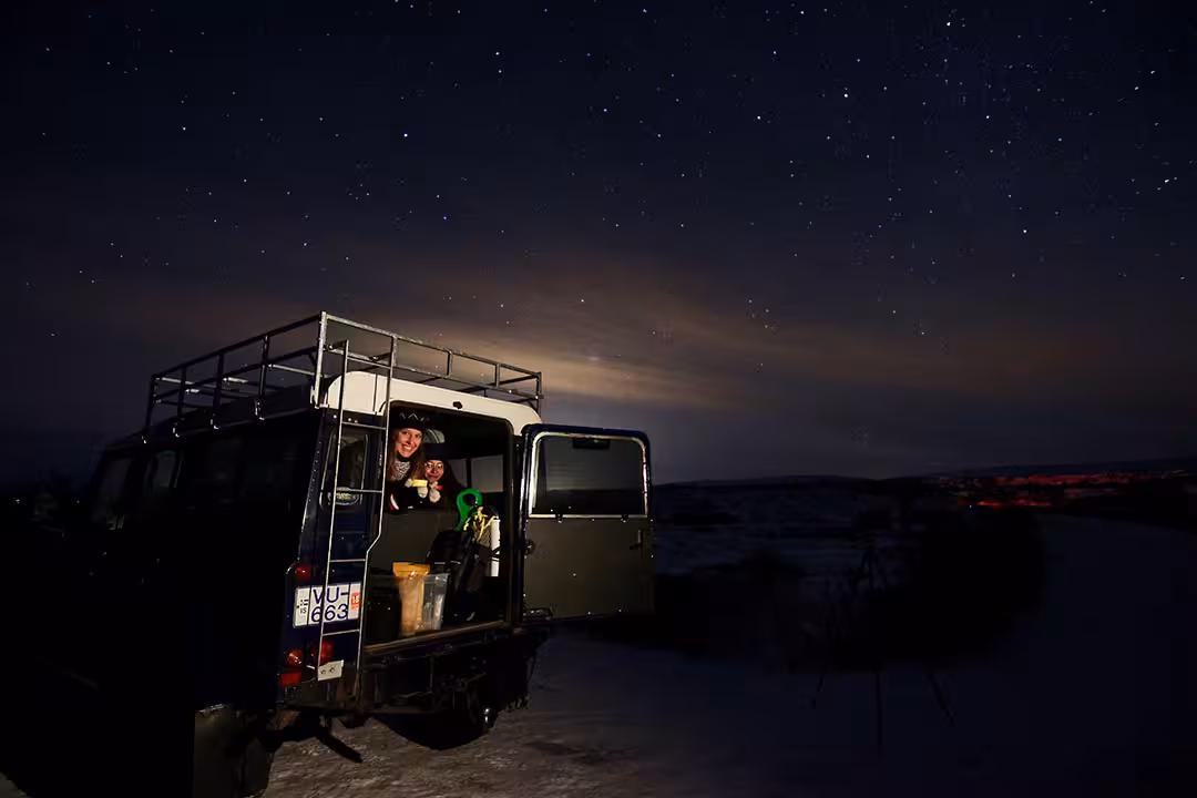 4x4 tour vehicle parked under a star-filled Arctic sky, ideal Northern Lights chase and stargazing night excursion