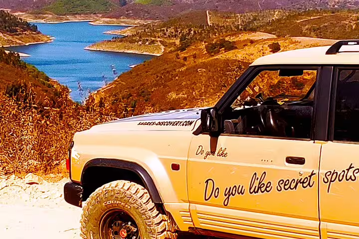 4x4 vehicle parked near a scenic water view on the West Coast Natural Park half-day tour, promising secret spots.