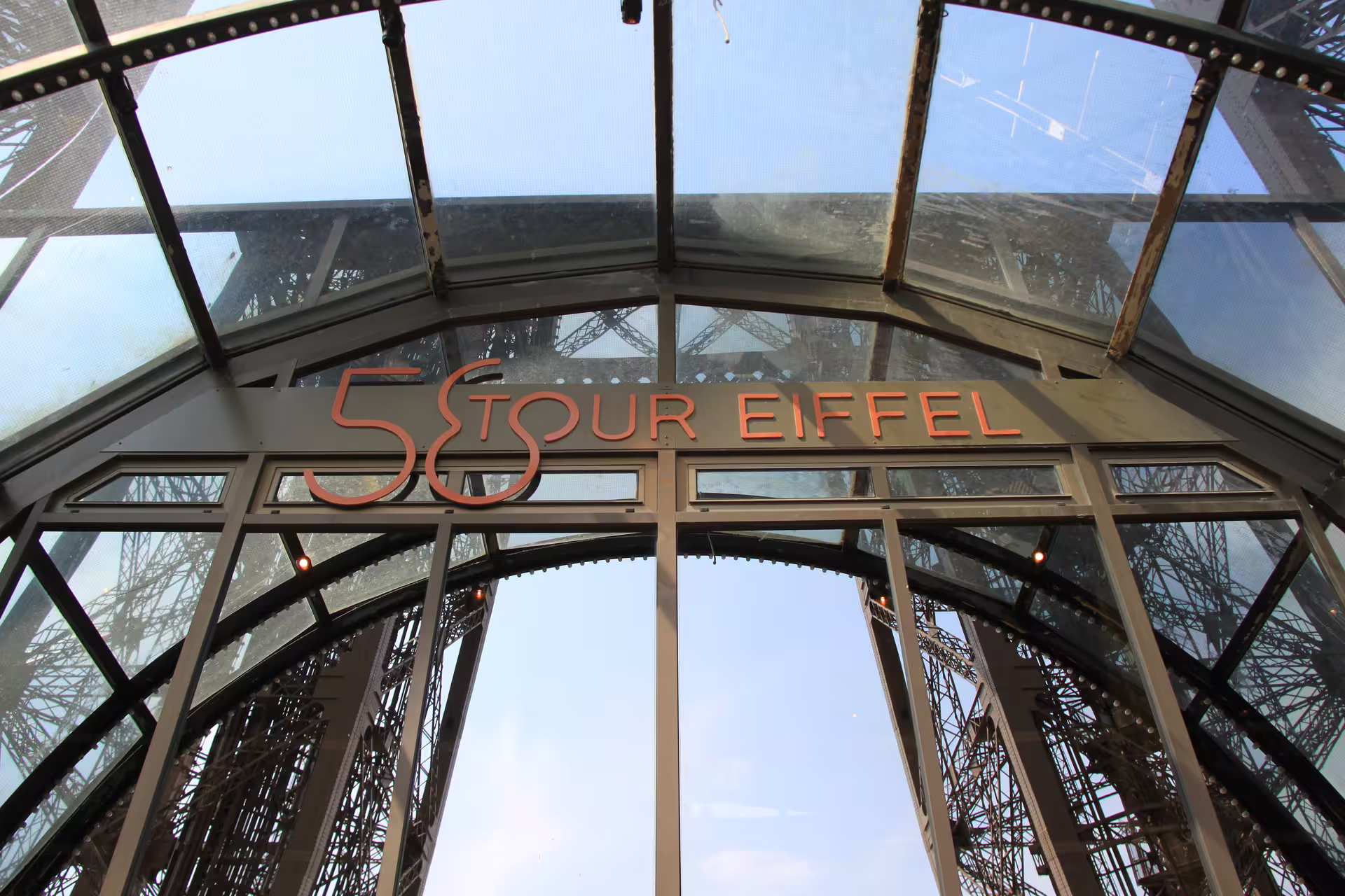 58 Tour Eiffel restaurant sign inside the Eiffel Tower glass entrance, Paris