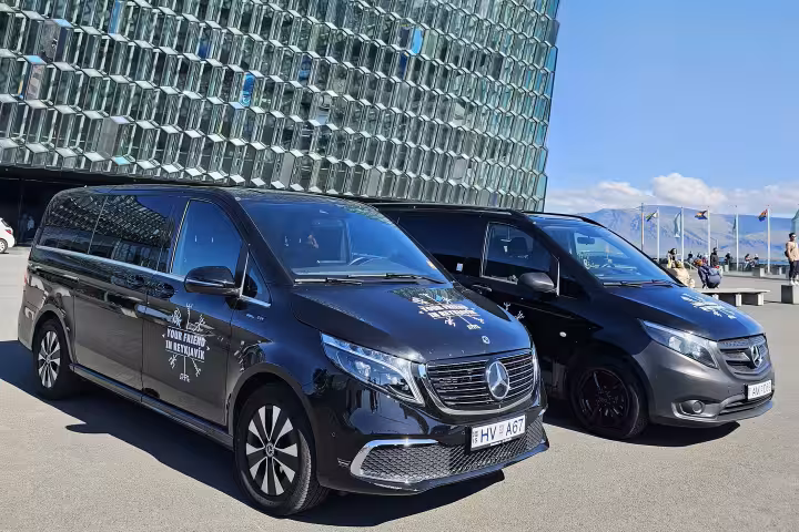 Two vans parked in front of the Harpa Concert Hall in Reykjavik