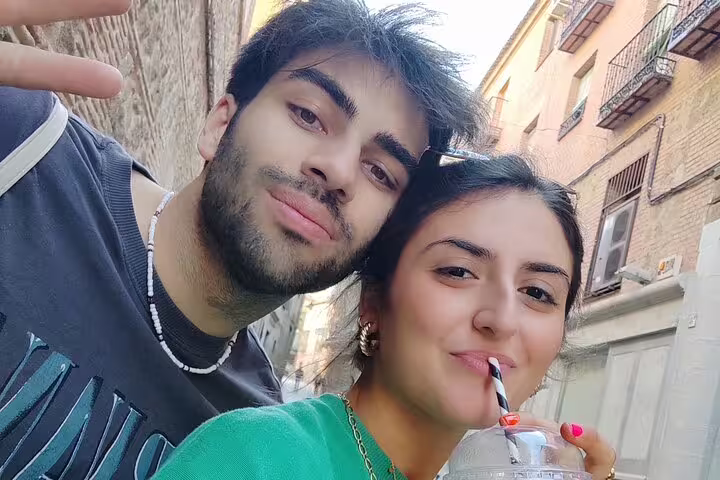 Couple enjoying a selfie in Toledo's medieval old town narrow streets during a guided walking history tour