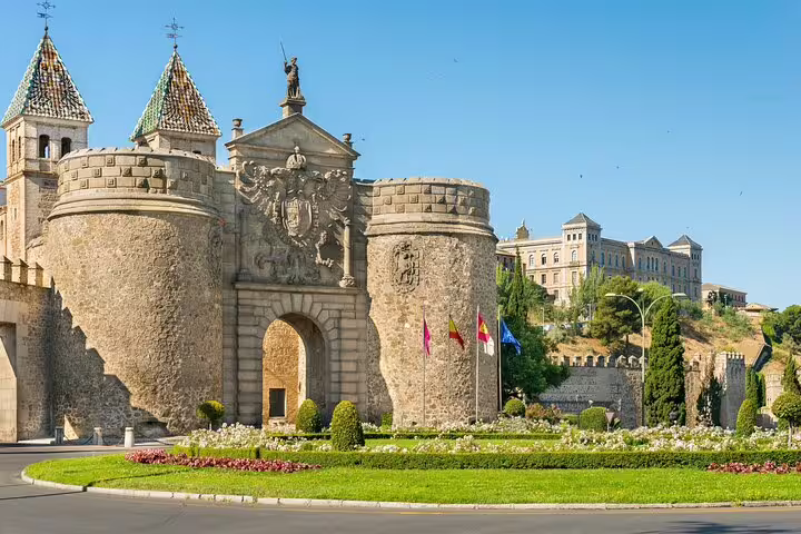 Historic Puerta de Bisagra gateway in Toledo Spain with medieval stone towers on a guided walking tour