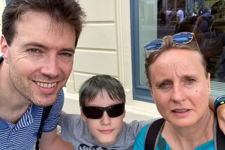 Happy family enjoying a self-guided Berlin Wall escape stories walking tour through historic Berlin streets