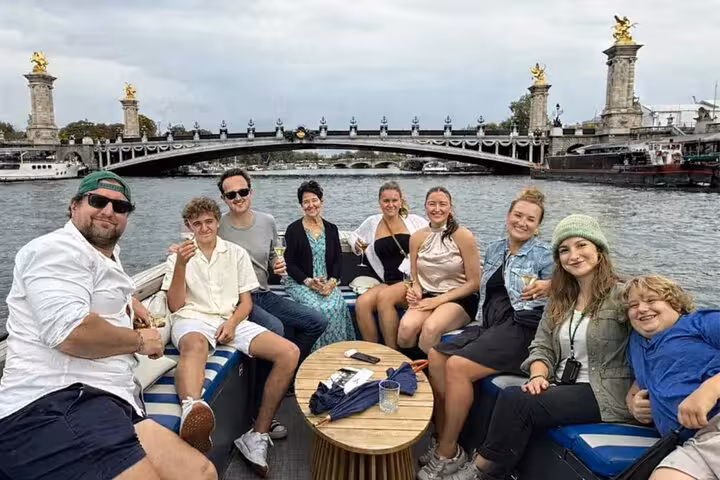 Seine river cruise group with drinks near Pont Alexandre III, a great add-on to Eiffel Tower restaurant lunch or dinner.