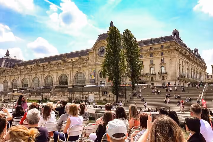 Paris riverside crowd near Musée d’Orsay on Seine cruise, a perfect pairing with Eiffel Tower dining upgrades