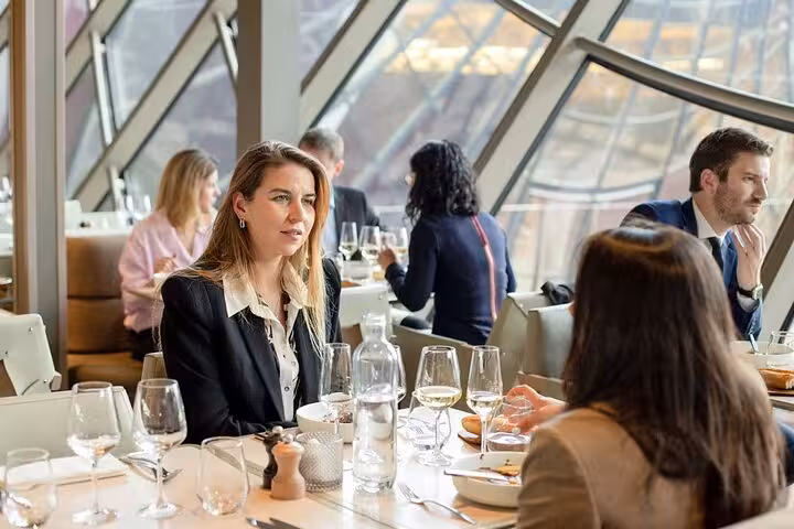 Guests enjoying fine dining inside the Eiffel Tower restaurant with city views, lunch or dinner experience upgrade