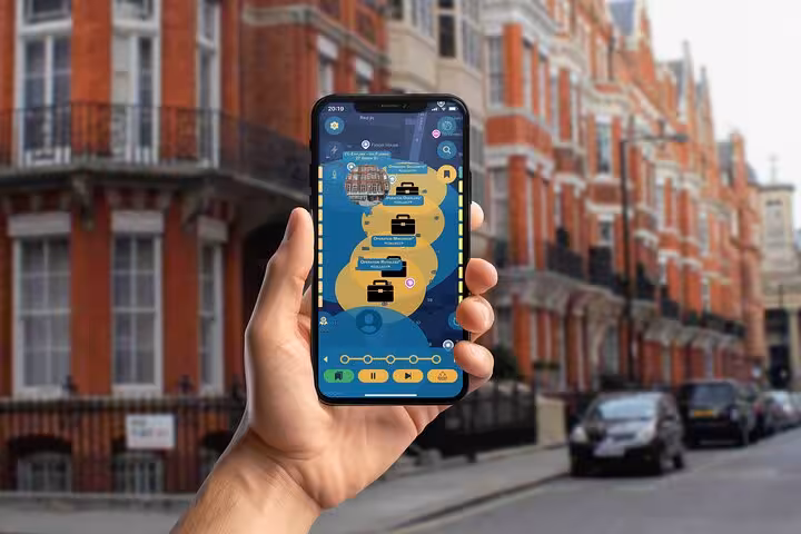 Hand holding a phone displaying James Bond self-guided app game tour map on a classic London street