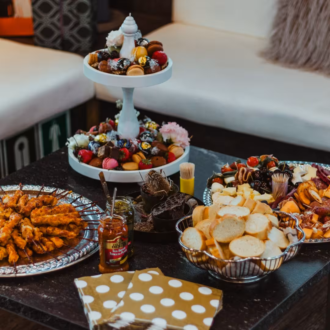 Elegant gourmet food spread with macarons and charcuterie aboard an exclusive Northern Lights luxury cruise dining experience