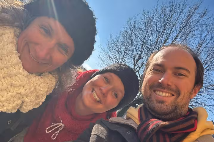 Three happy friends taking a winter selfie outdoors enjoying the Lyon haunted self-guided ghost hunt walking tour