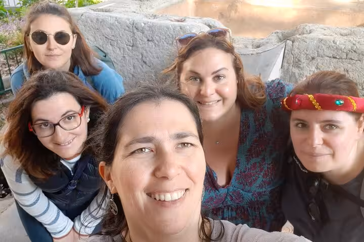 Group of five smiling women taking a fun selfie during the Lyon haunted walking tour self-guided ghost hunt game
