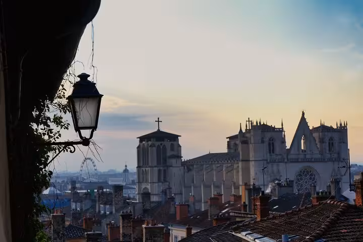 Eerie dusk view of Lyon cathedral skyline with vintage lantern perfect for a haunted walking ghost tour experience