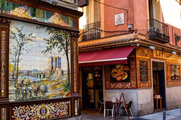 Colorful hand-painted ceramic tile mural on La Fragua restaurant facade in historic Madrid old town