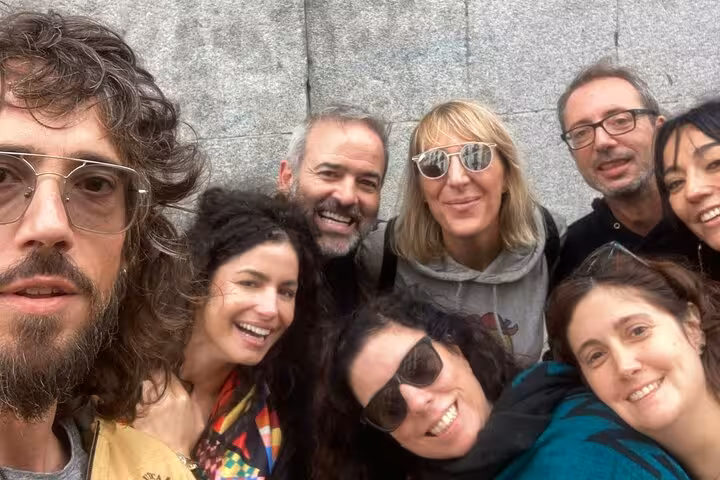 Happy group of friends taking a selfie during self-guided walking tour exploring Madrid Inquisition history