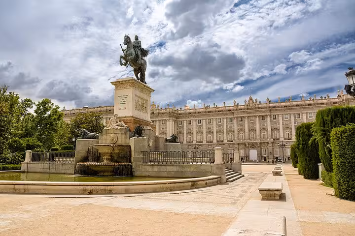 Equestrian statue of Felipe IV with Royal Palace backdrop on Madrid self-guided Inquisition walking tour