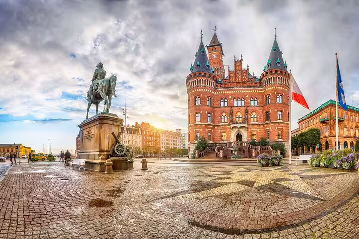 Panoramic view of Helsingborg Town Hall and equestrian statue at sunset on a self-guided old town tour