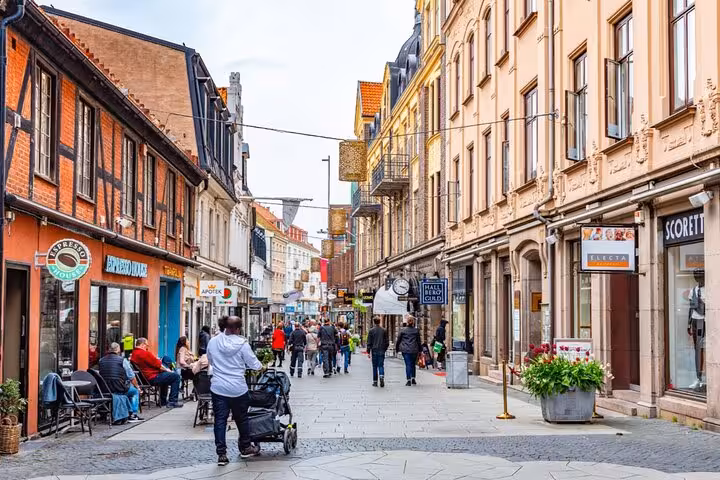 Bustling pedestrian street in Helsingborg Old Town with historic colorful buildings and local shops