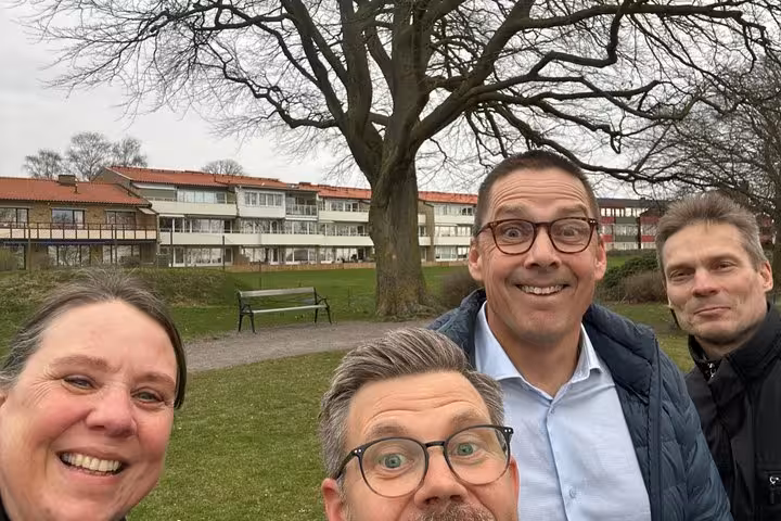 Happy group of tourists enjoying a self-guided walking tour in Helsingborg Old Town park area