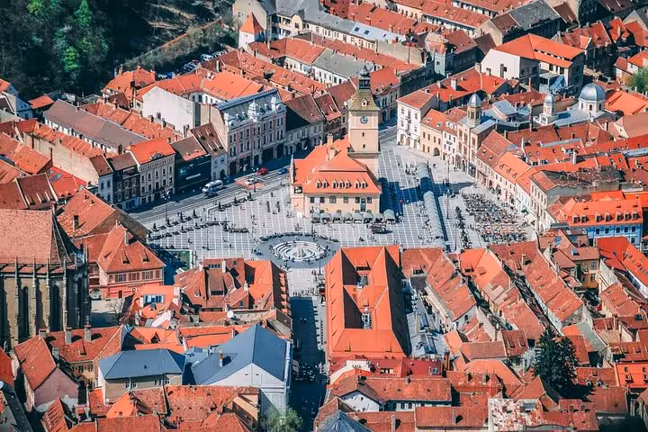 Aerial view of medieval Brasov old town with red rooftops and Council Square on a self-paced walking tour