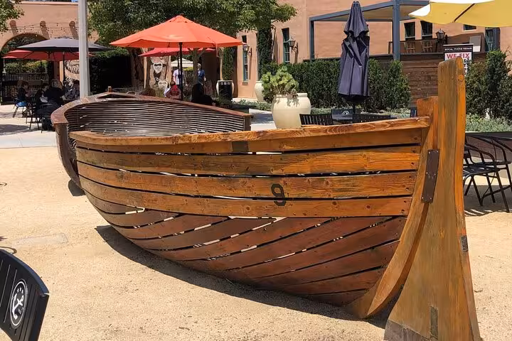 Historic wooden boat display at Liberty Station San Diego open-air plaza on a self-guided walking tour