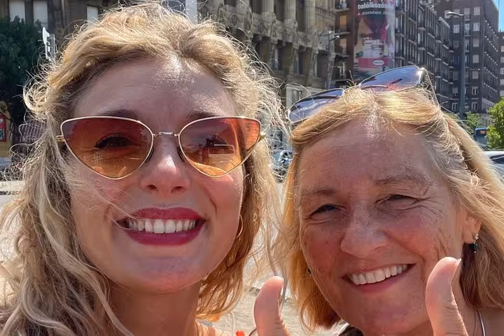Two happy women smiling in Budapest city center during a fun self-guided detective mystery walking tour