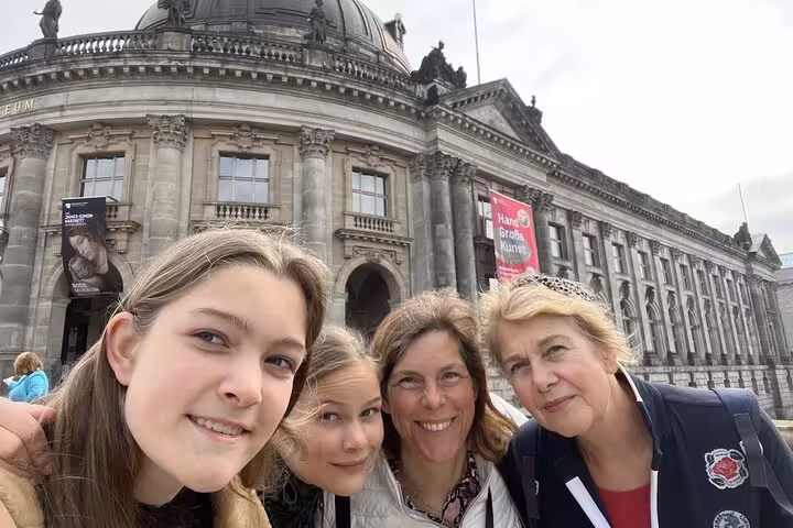 Four women smiling together in front of the historic Bode Museum on a Berlin WW2 self-guided walking tour