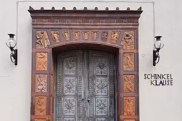 Ornate terracotta doorway of Schinkel Klause featuring classical reliefs on Berlin WW2 self-guided walking tour