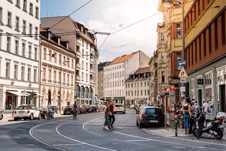 Busy Berlin street with tram tracks and historic buildings explored on a WW2 self-guided smartphone walking tour