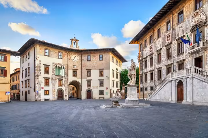 Historic Piazza dei Cavalieri in Pisa featuring ornate buildings and statue on a self-guided walking tour